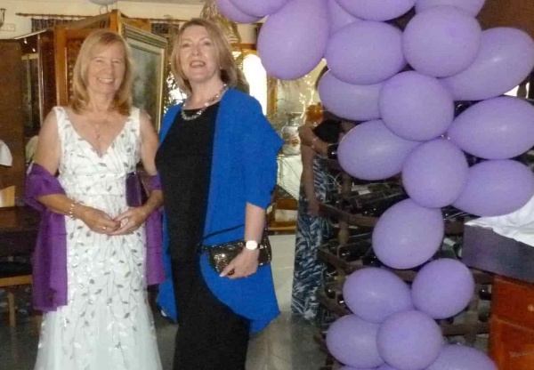 2 ladies in evening wear entering the venue 