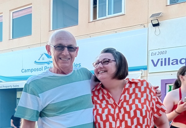 a couple casually dressed and smiling