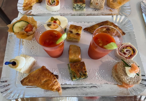 bite size canapes of salmon, ham, quiches, gazpacho on  doyley and silver tray