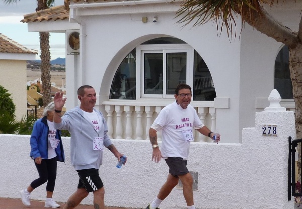 smiling people walking in the race for life 2024