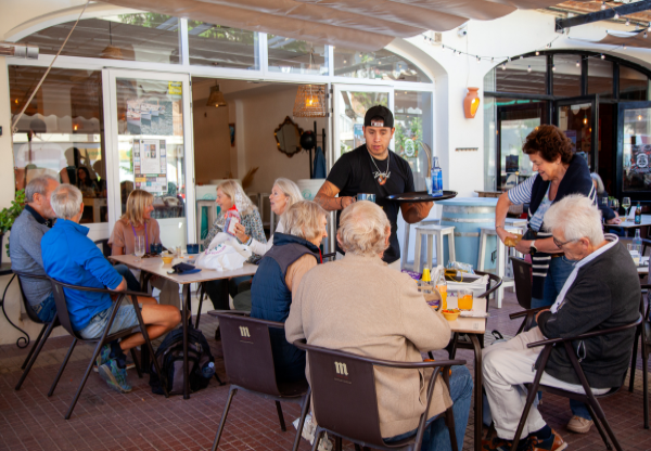 people chatting at a table in a cafe