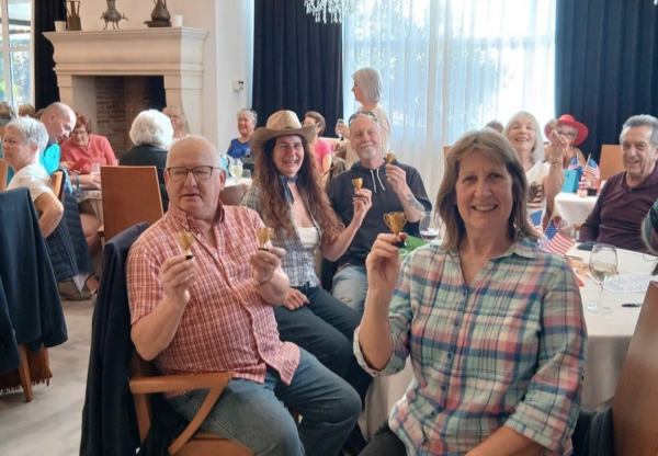 quiz winners holding tiny prize cups