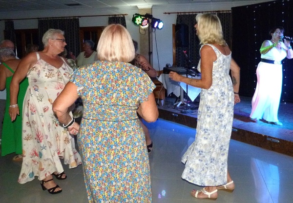 Guests dancing as a singer performs at the MABS Mazarrón anniversary party